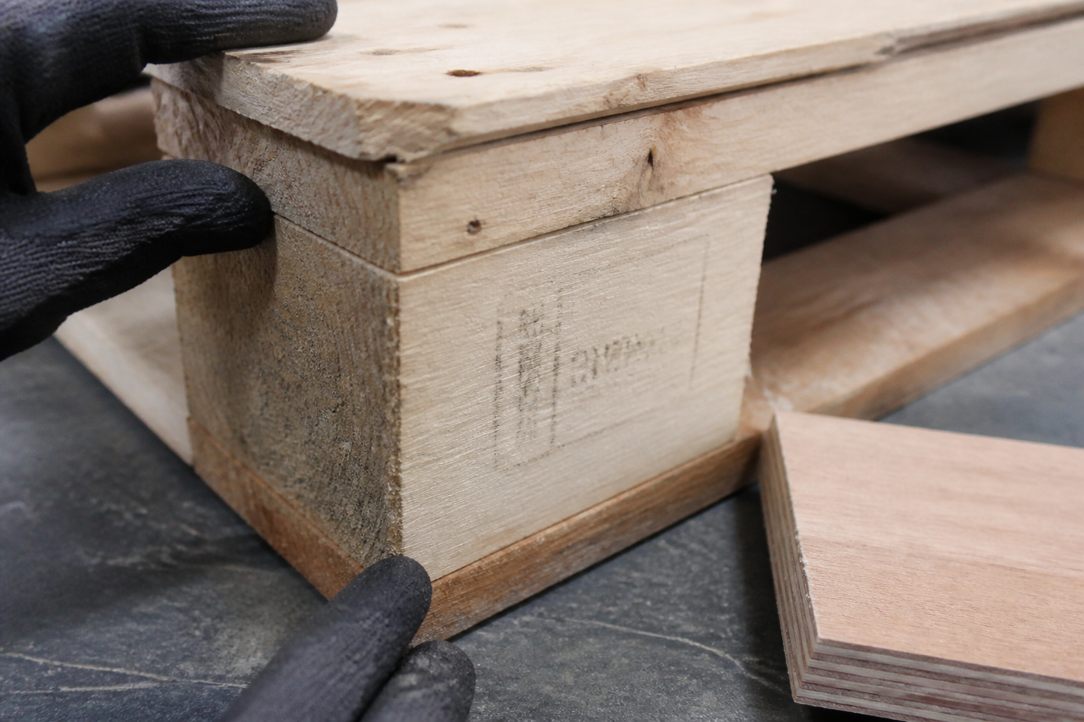 Close inspection of a clean wood pallet corner and plywood sample